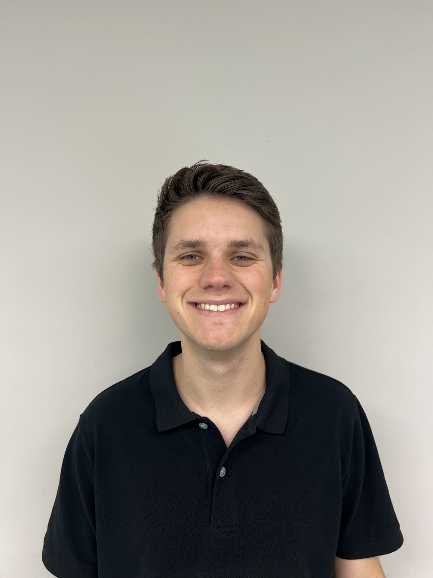 Smiling man in black polo shirt. Smiling man in black polo shirt.